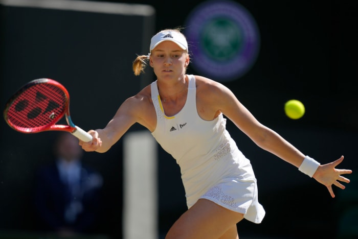 Elena Rybakina returns a ball during a Wimbledon match.